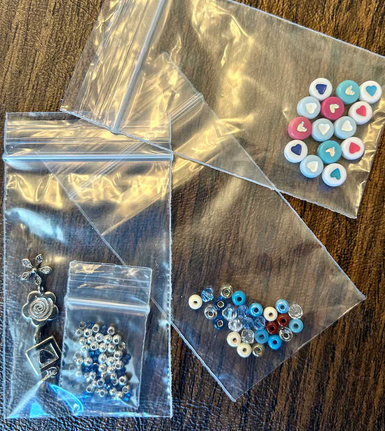 Large Hebrew letter bracelet making kit by Pretty Beans with blue beads and charms for DIY jewelry creation.
