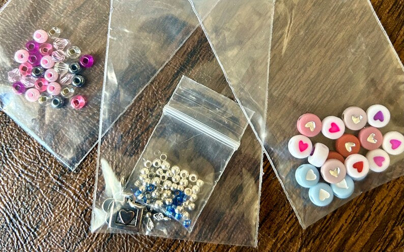Large Hebrew letter bead bracelet making kit by Pretty Beans featuring red beads and DIY jewelry tools for crafting bracelets.
