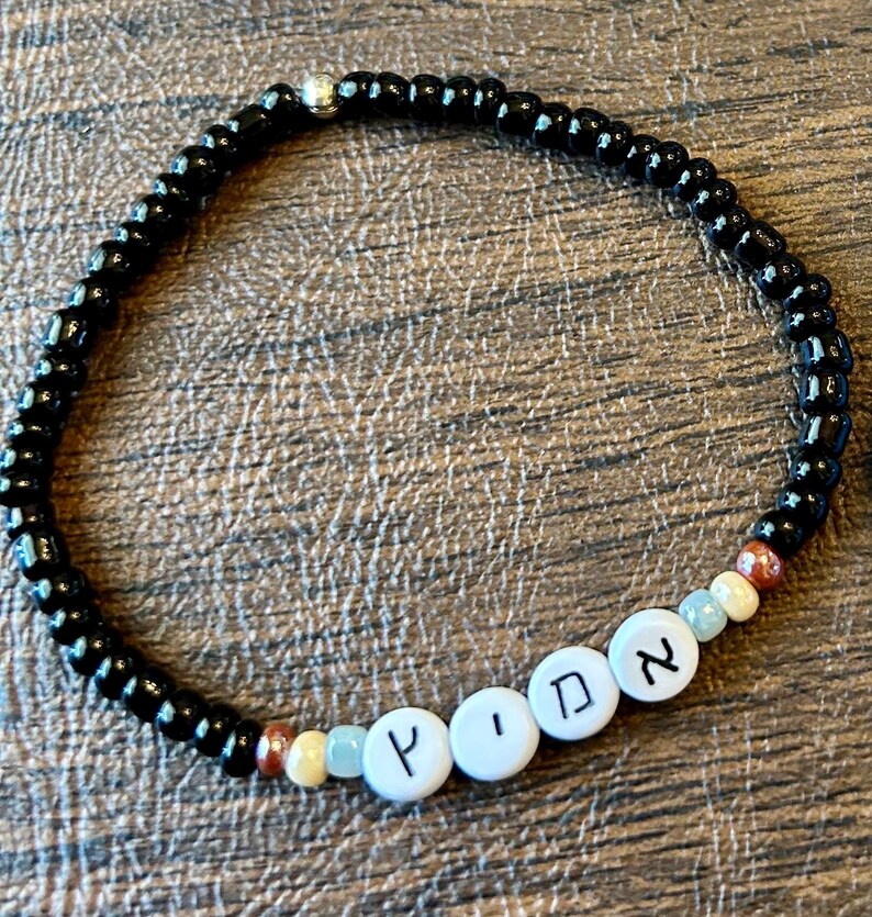 DIY Hebrew letter bracelet making kit by Pretty Beans featuring seed beads, silver charms, and tools for creating personalized jewelry.