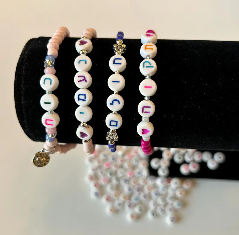 Colorful Hebrew alphabet letter beads for jewelry making, 7mm size, by Pretty Beans, shown in new packaging for DIY craft projects.