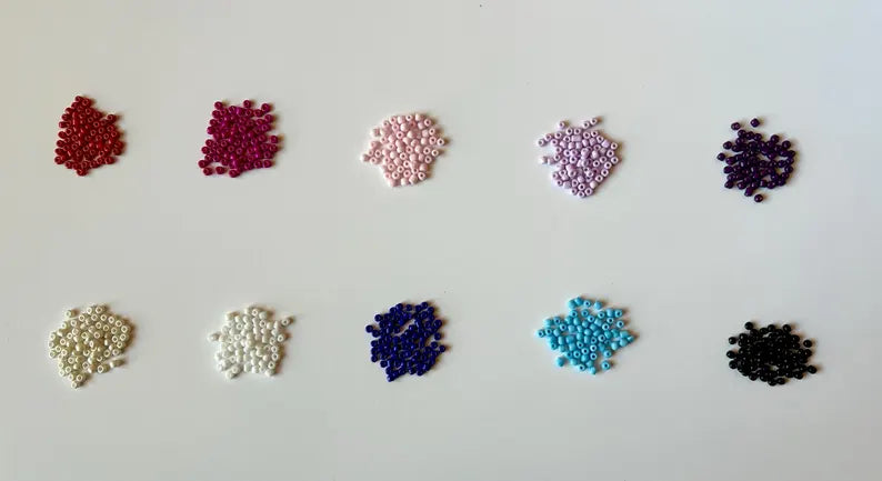 DIY jewelry kit by Pretty Beans featuring seed beads, alphabet beads, silver plated charms for bracelet making craft projects.
