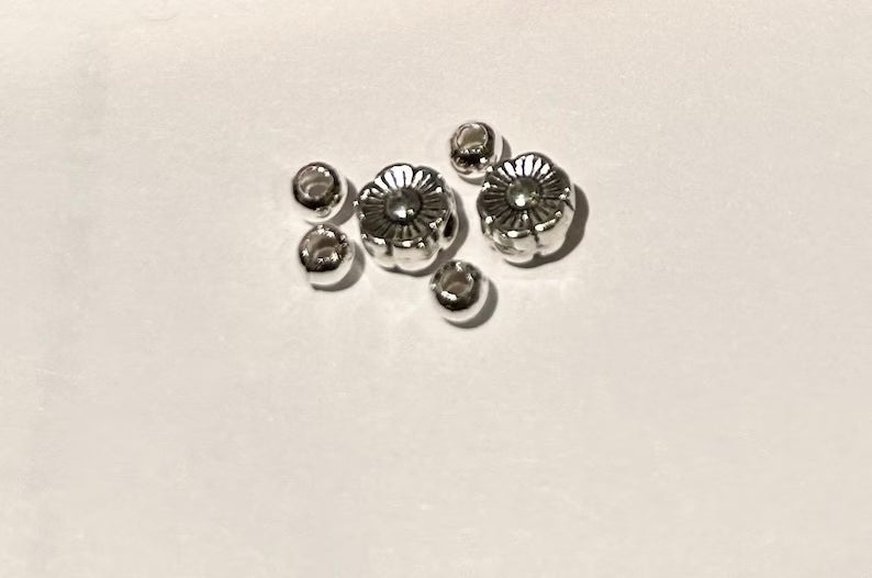 Red Hebrew letter beads set with silver accents and glass spacers, featuring the Hebrew alphabet for jewelry making.