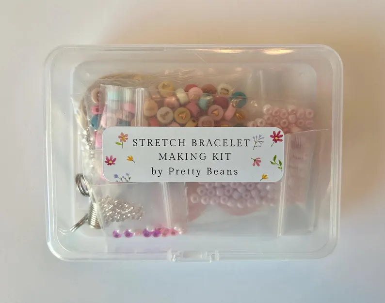 DIY Pretty Beans bracelet making kit with seed beads, letter charms, and silver charms for creating custom jewelry.
