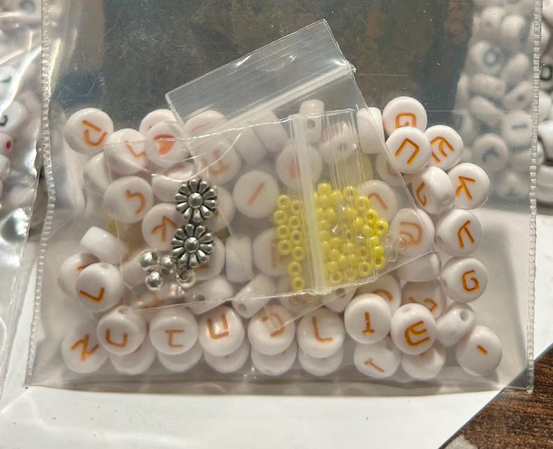 Pink Hebrew letter beads, 7mm, with hearts, tiny spacers, and silver-plated accents, perfect for jewelry making by Pretty Beans.