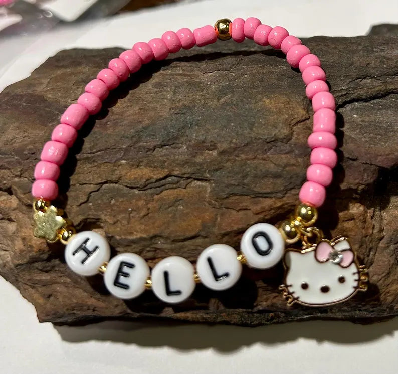 DIY Hello Kitty stretch bracelet making kit by Pretty Beans featuring colorful beads and charms for kids' jewelry crafts.