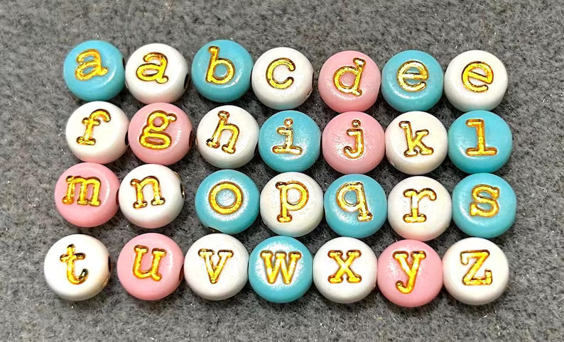 Lowercase gold alphabet beads featuring 7mm typewriter font, ideal for jewelry making and craft projects.