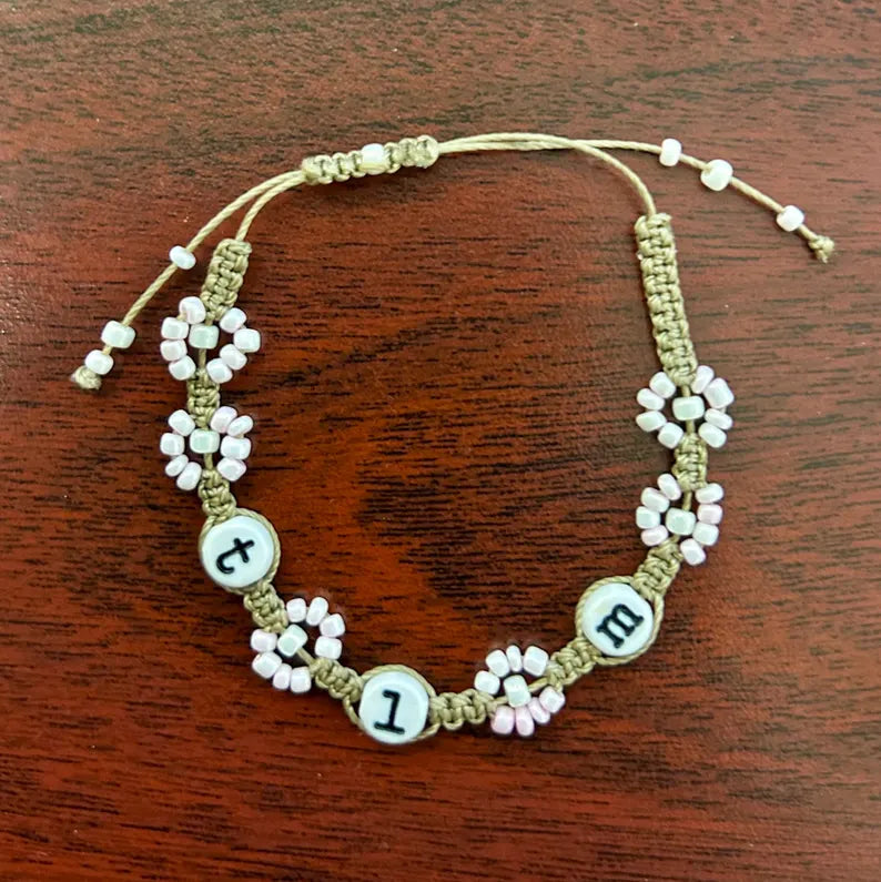 DIY jewelry making kit by Pretty Beans with seed beads, alphabet beads, and silver plated charms for creating custom bracelets.