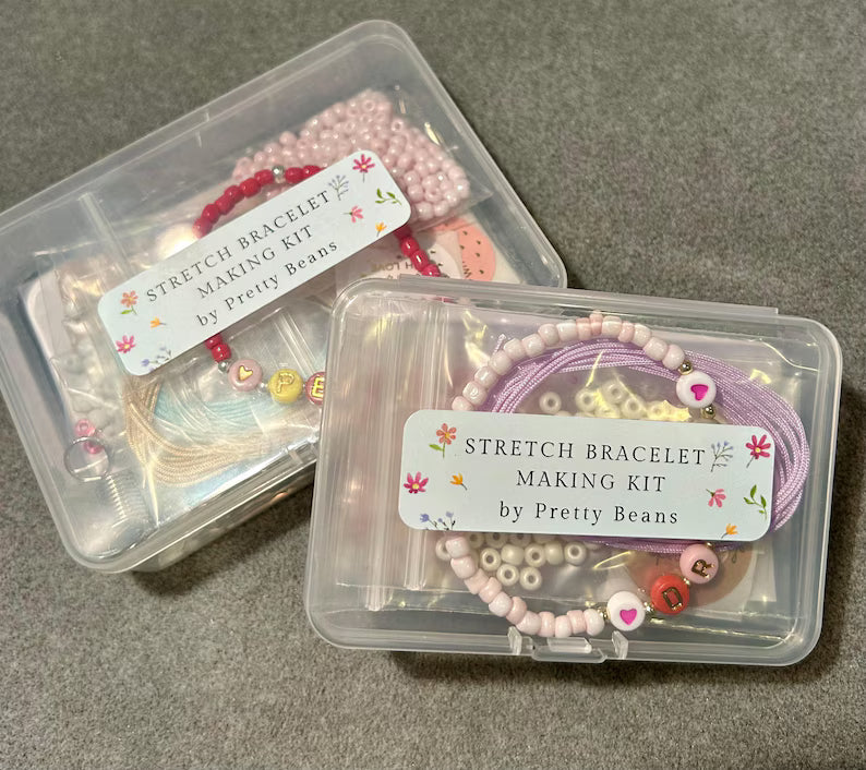 Pretty Beans DIY jewelry kit featuring seed beads, alphabet beads, and silver plated charms for bracelet making.