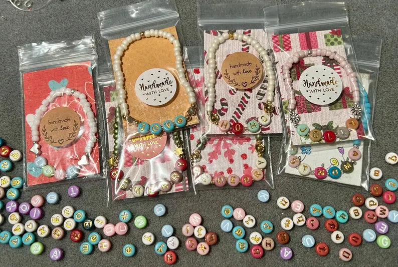 DIY jewelry kit by Pretty Beans with seed beads, alphabet beads, and silver plated charms for bracelet making.