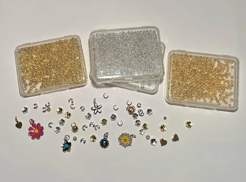 DIY jewelry kit by Pretty Beans featuring seed beads, alphabet beads, and silver plated charms for bracelet making.