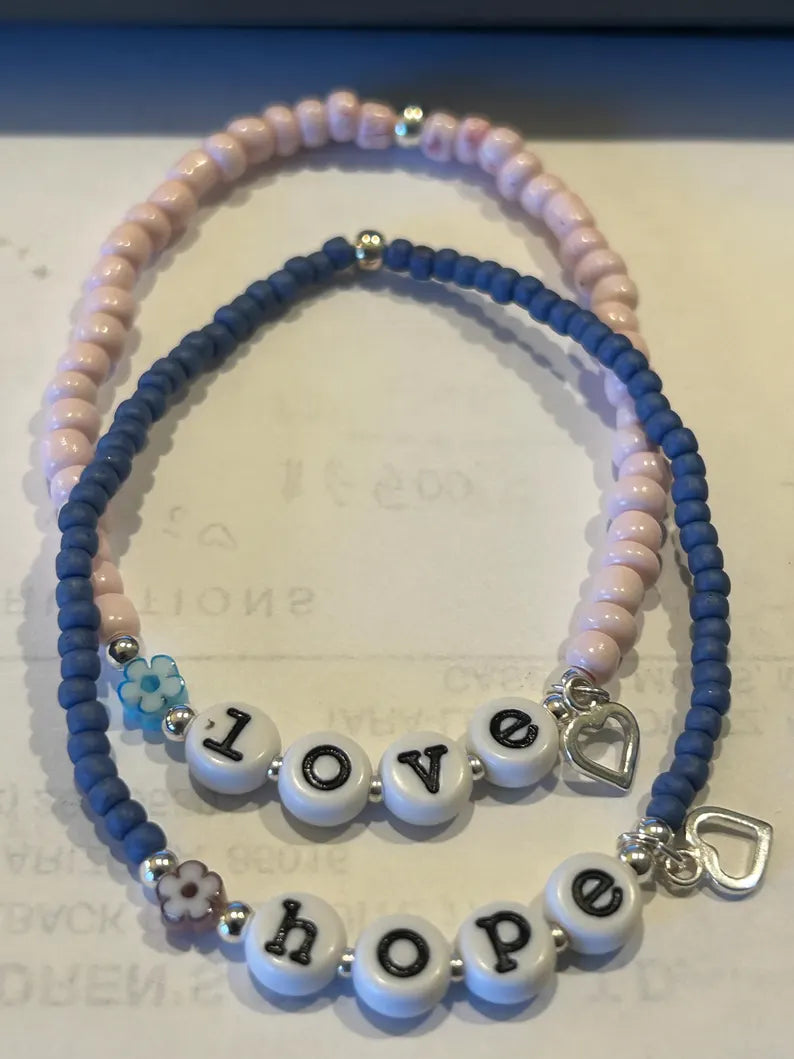 DIY jewelry kit by Pretty Beans with seed beads, alphabet beads, and silver-plated charms for bracelet making.