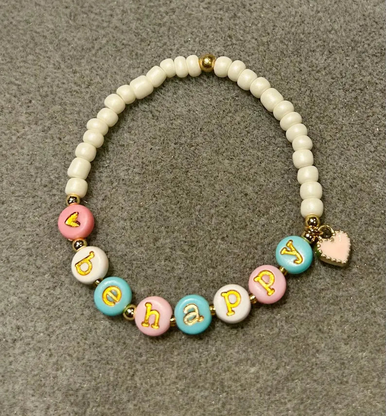 Lowercase gold alphabet beads featuring 7mm typewriter font, ideal for jewelry making from Pretty Beans.