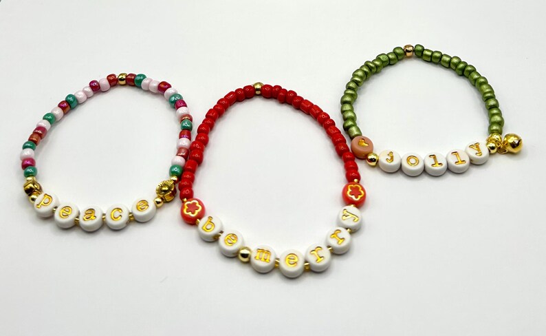 DIY holiday bracelet making kit by Pretty Beans featuring seed beads and lowercase alphabet beads for creative jewelry crafting.