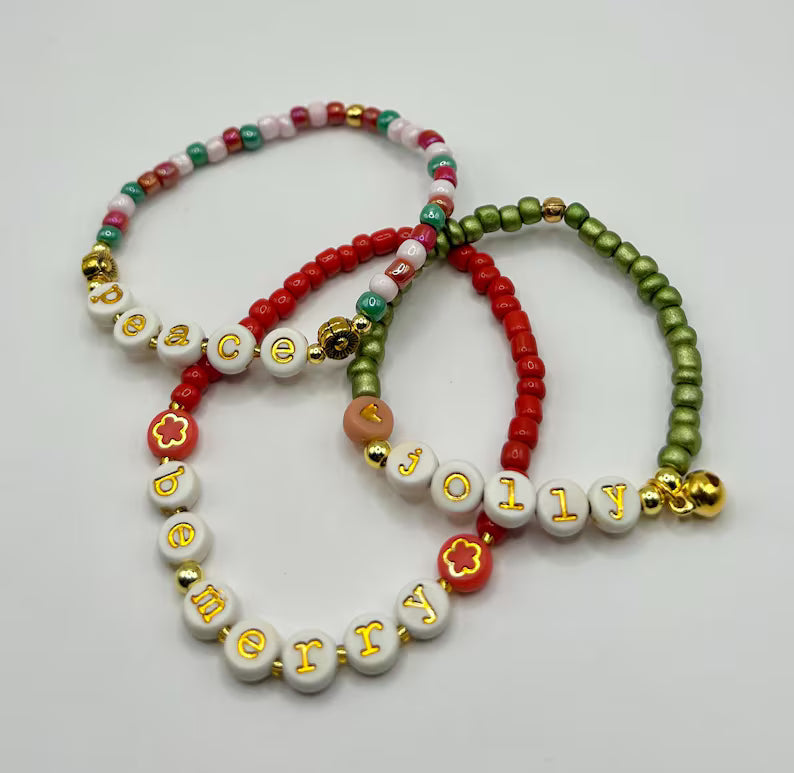 Pretty Beans DIY holiday bracelet making kit with seed beads and lowercase alphabet charms for jewelry crafting.