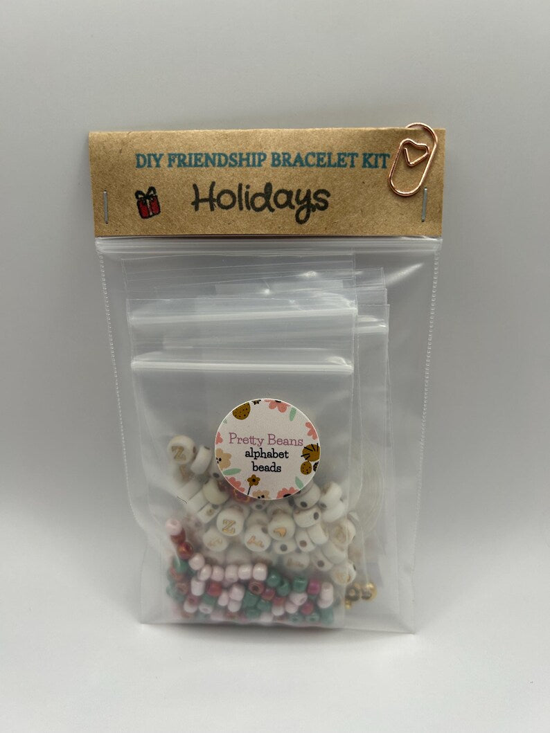 DIY holiday bracelet making kit by Pretty Beans with seed beads and lowercase alphabet charms for custom jewelry creation.