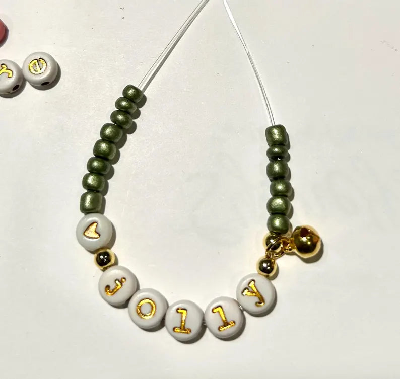 Lowercase gold alphabet beads in 7mm typewriter font, ideal for jewelry making, shown in a close-up image.