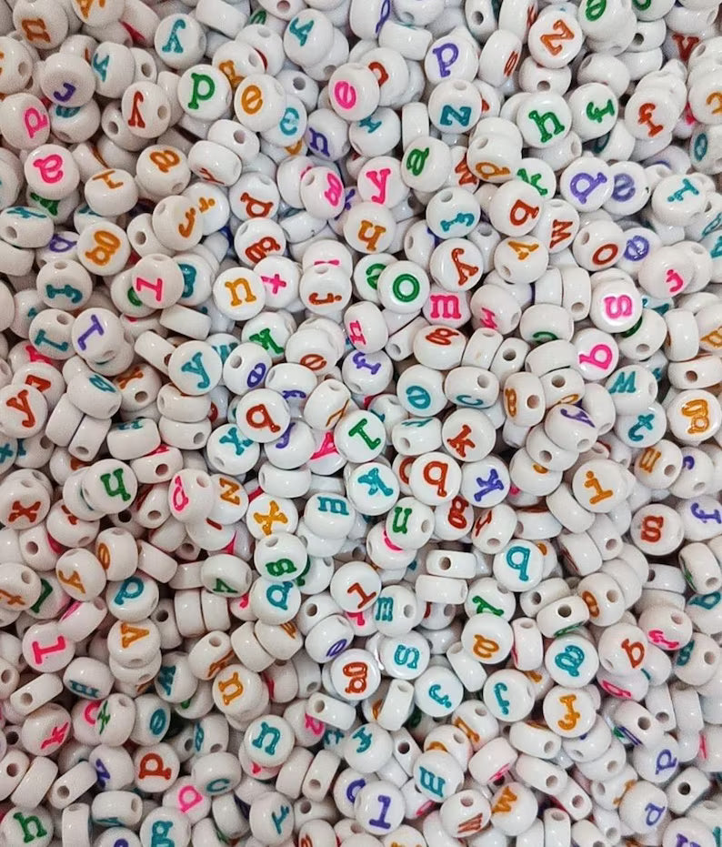Colorful lowercase alphabet beads in typewriter font, 7mm size, arranged in a cluster showcasing vibrant, playful lettering.