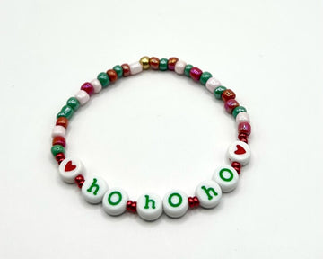 Pretty Beans DIY holiday bracelet making kit with seed beads and lowercase alphabet charms for custom jewelry crafting.