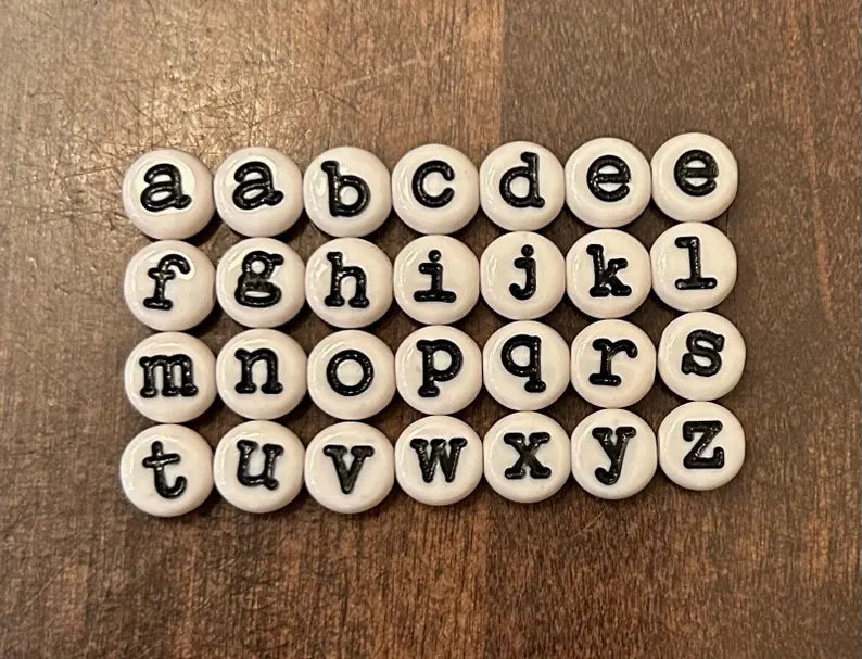 DIY teacher bracelet making kit by Pretty Beans with seed beads, letter beads, and apple charms for customizing jewelry.