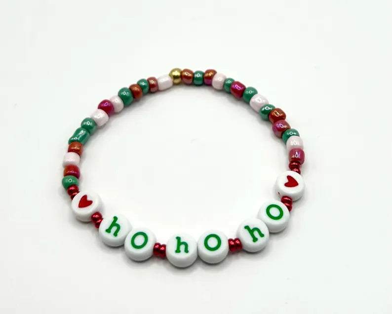 Colorful lowercase alphabet beads for jewelry making, 7mm letter beads by Pretty Beans arranged in a close-up image.
