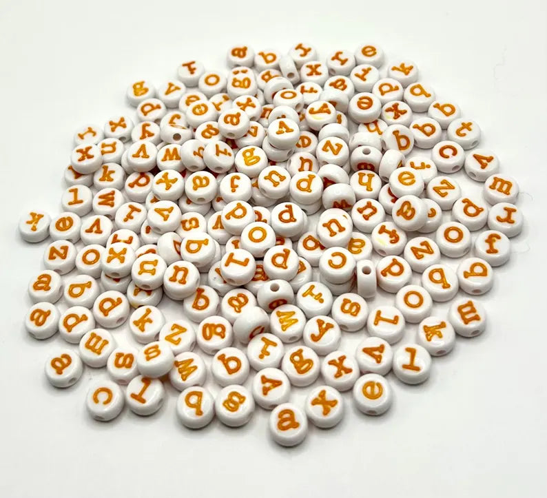 Yellow lowercase alphabet beads with 7mm typewriter font, featuring round beads with black lettering for jewelry making.