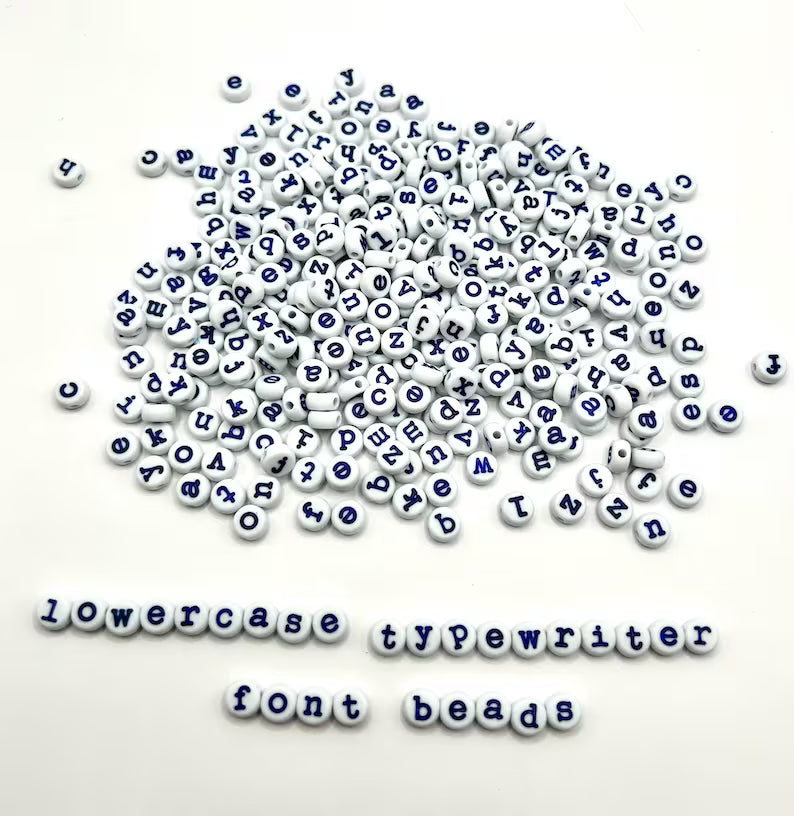 Light blue lowercase typewriter font alphabet beads with navy letters, 7mm, for jewelry making by Pretty Beans.