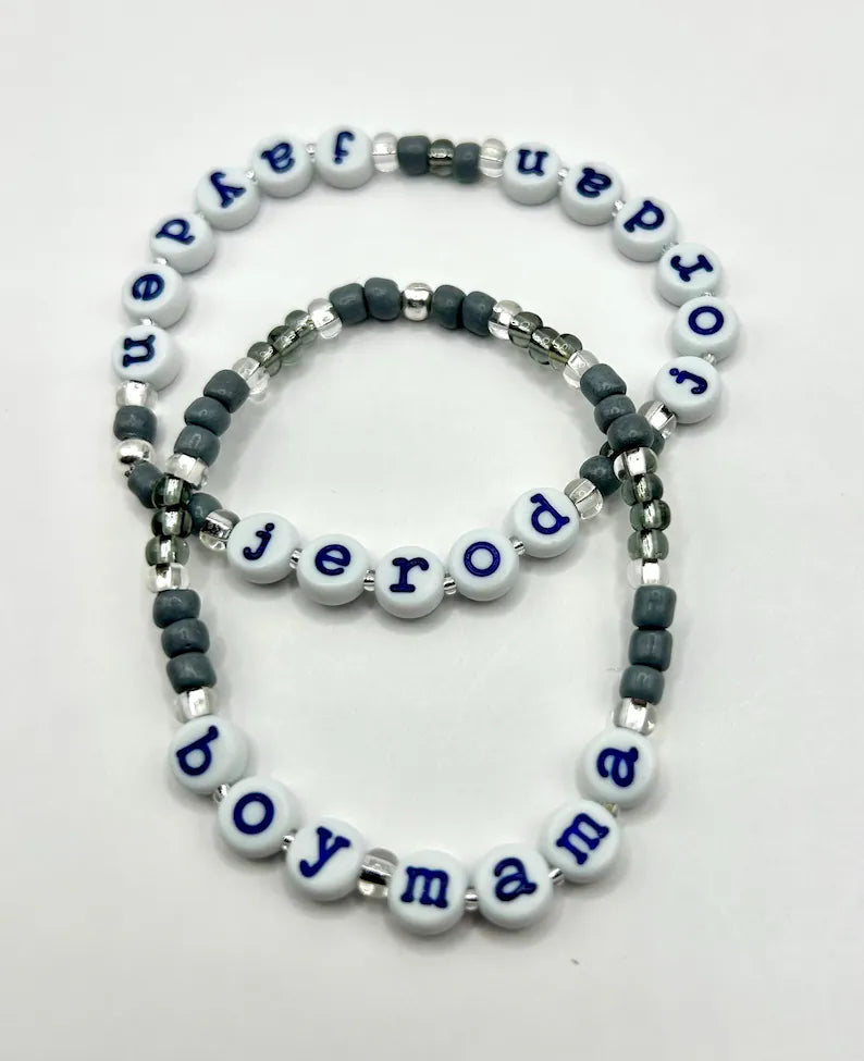 Light blue lowercase typewriter font alphabet beads with navy letters, 7mm size, for jewelry making by Pretty Beans.