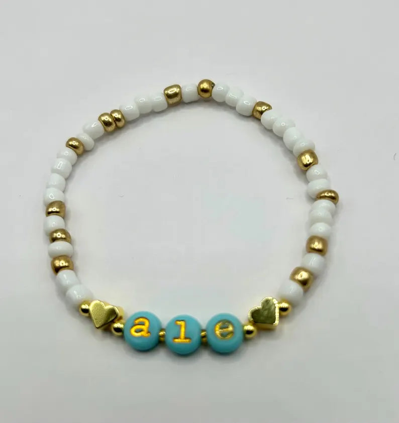 Gold lowercase alphabet beads in 7mm typewriter font for jewelry making, featuring Pretty Beans brand beads.