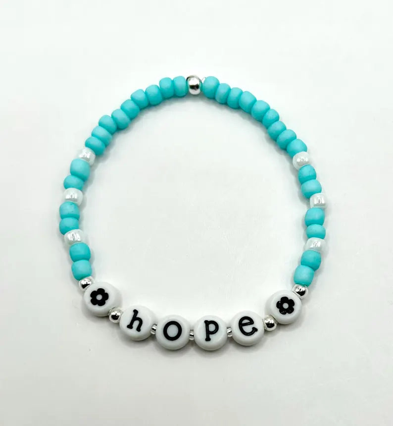 White lowercase alphabet beads with black letters, 7mm size, designed for jewelry making by Pretty Beans.