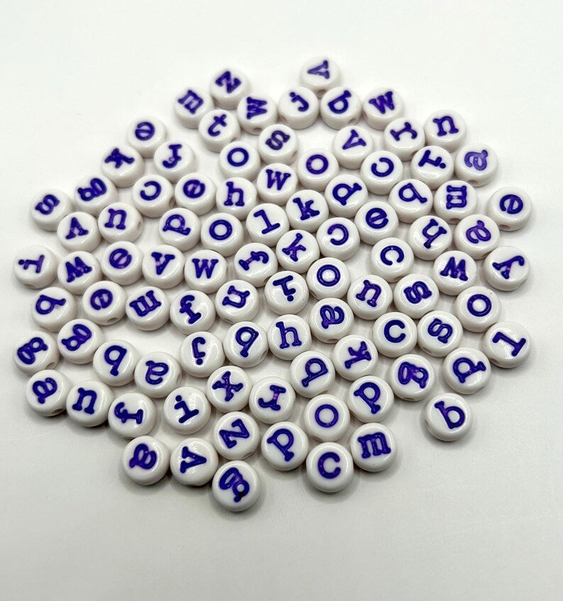Purple alphabet beads with typewriter font, 7mm size, 120-piece set from Pretty Beans, showing beads with letter engravings.