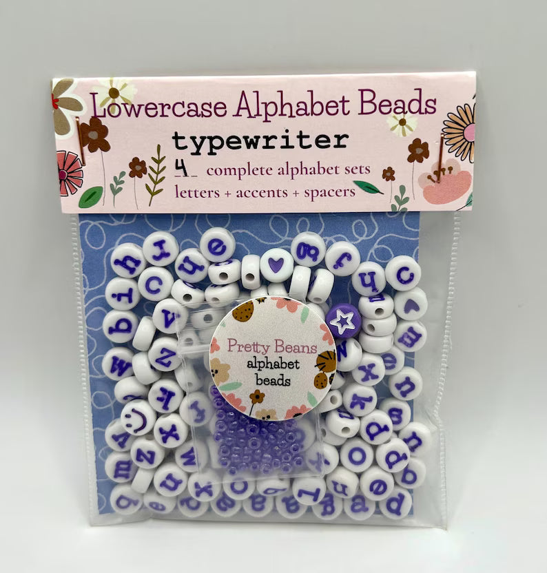Purple alphabet beads with typewriter font, 7mm size, 120-piece set from Pretty Beans, showing beads with letter engravings.