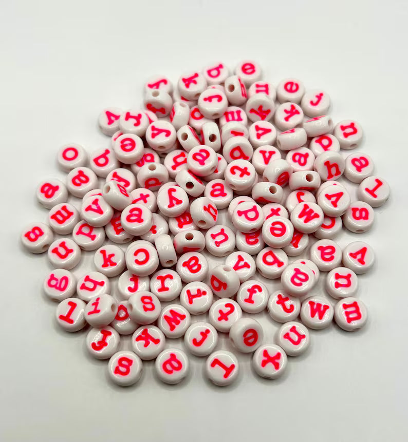 Hot pink lowercase alphabet beads in 7mm typewriter font, perfect for jewelry making, shown in a set of 120 pieces.