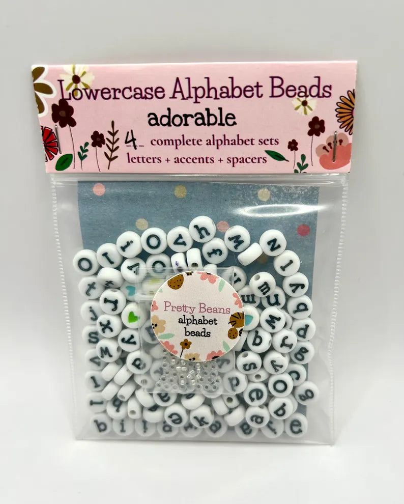 White lowercase alphabet beads with black letters, 7mm font, ideal for jewelry making, by Pretty Beans.