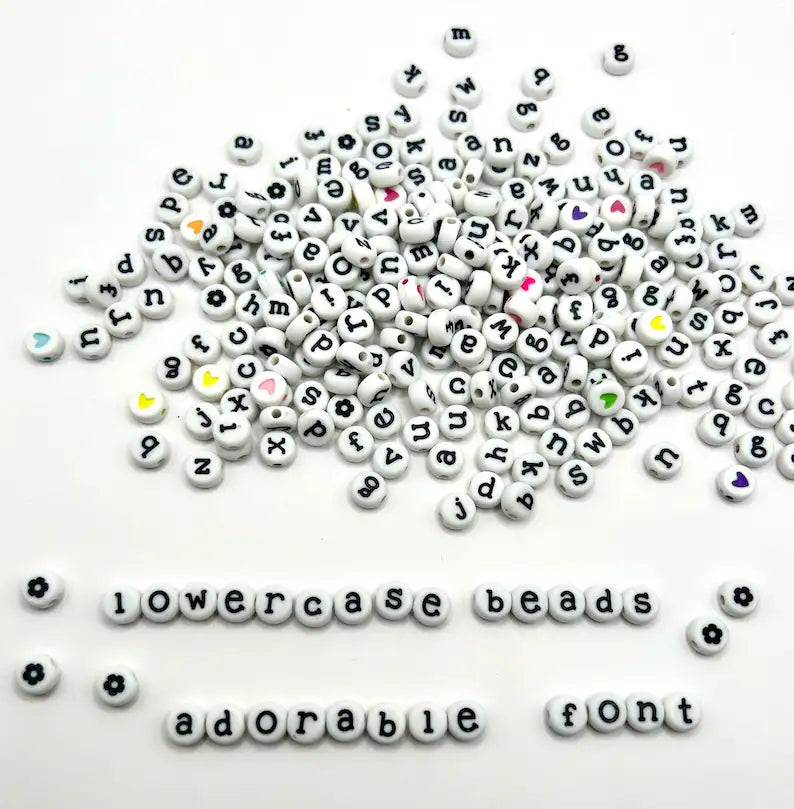 White lowercase alphabet beads with black letters, 7mm font, ideal for jewelry making, by Pretty Beans.
