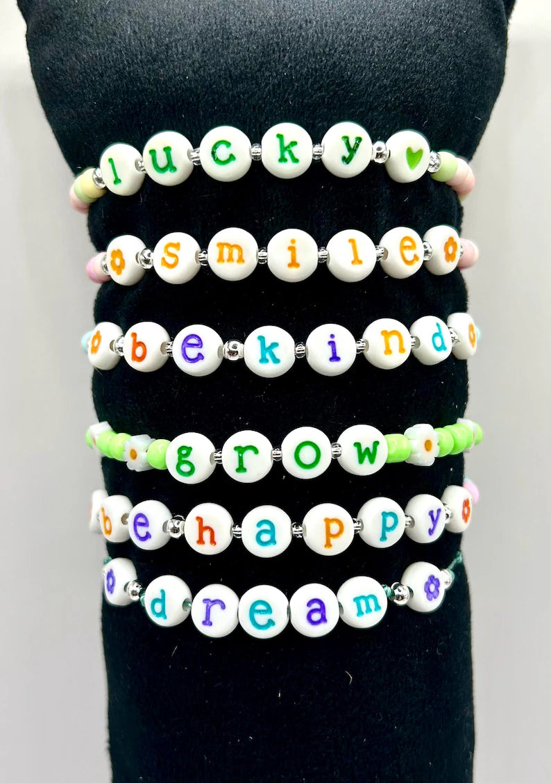 Colorful lowercase alphabet beads with 7mm size, perfect for jewelry making by Pretty Beans, shown in a close-up image.