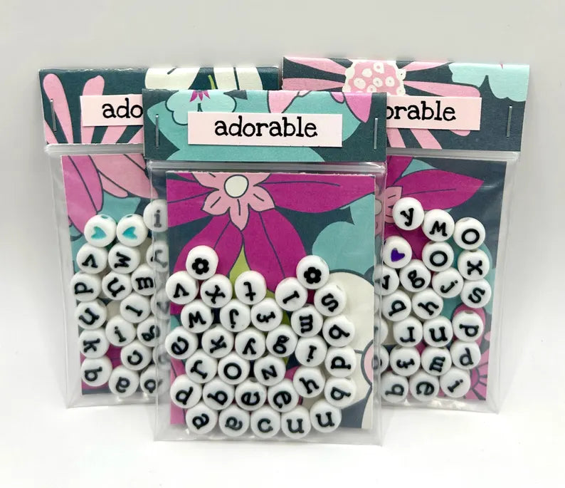 White lowercase alphabet beads with black lettering, 7mm size, for jewelry making by Pretty Beans.